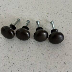 Four dark brown or pewter knobs for cabinets or drawers sturdy